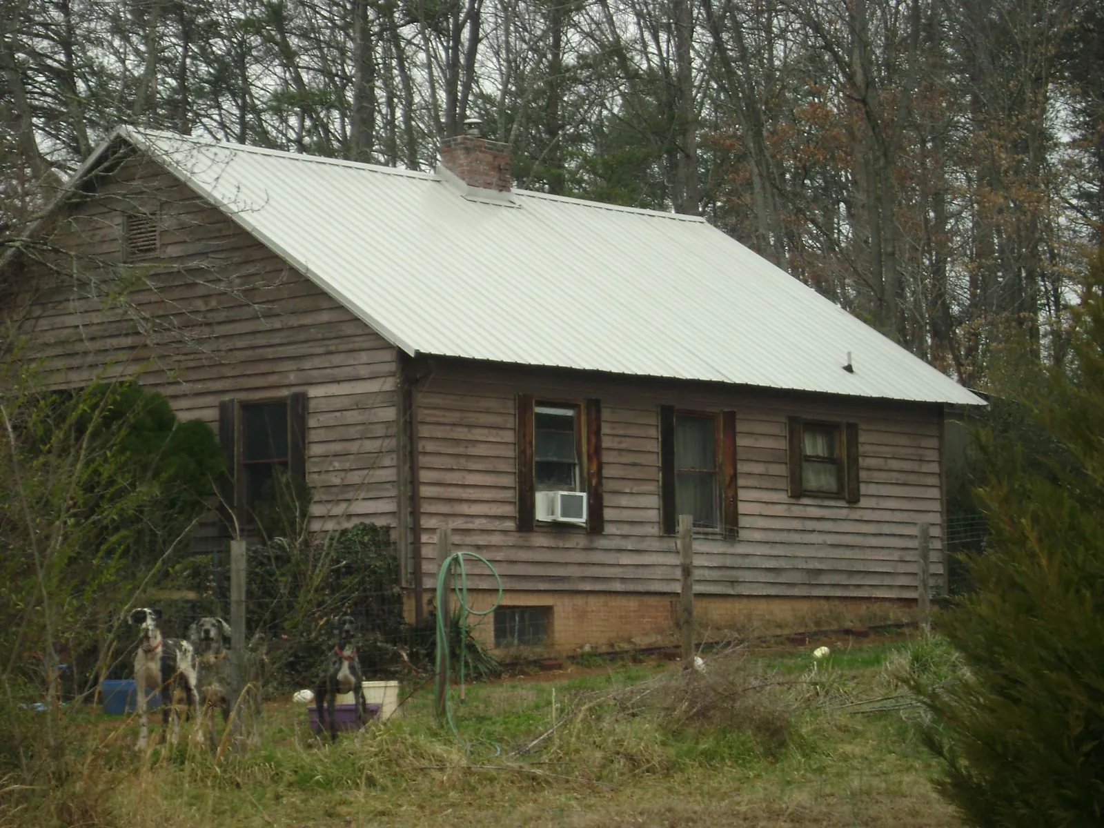 White metal roof on an old wood sided farmhouse, from a Metal Roof Installation job in Snow Hill